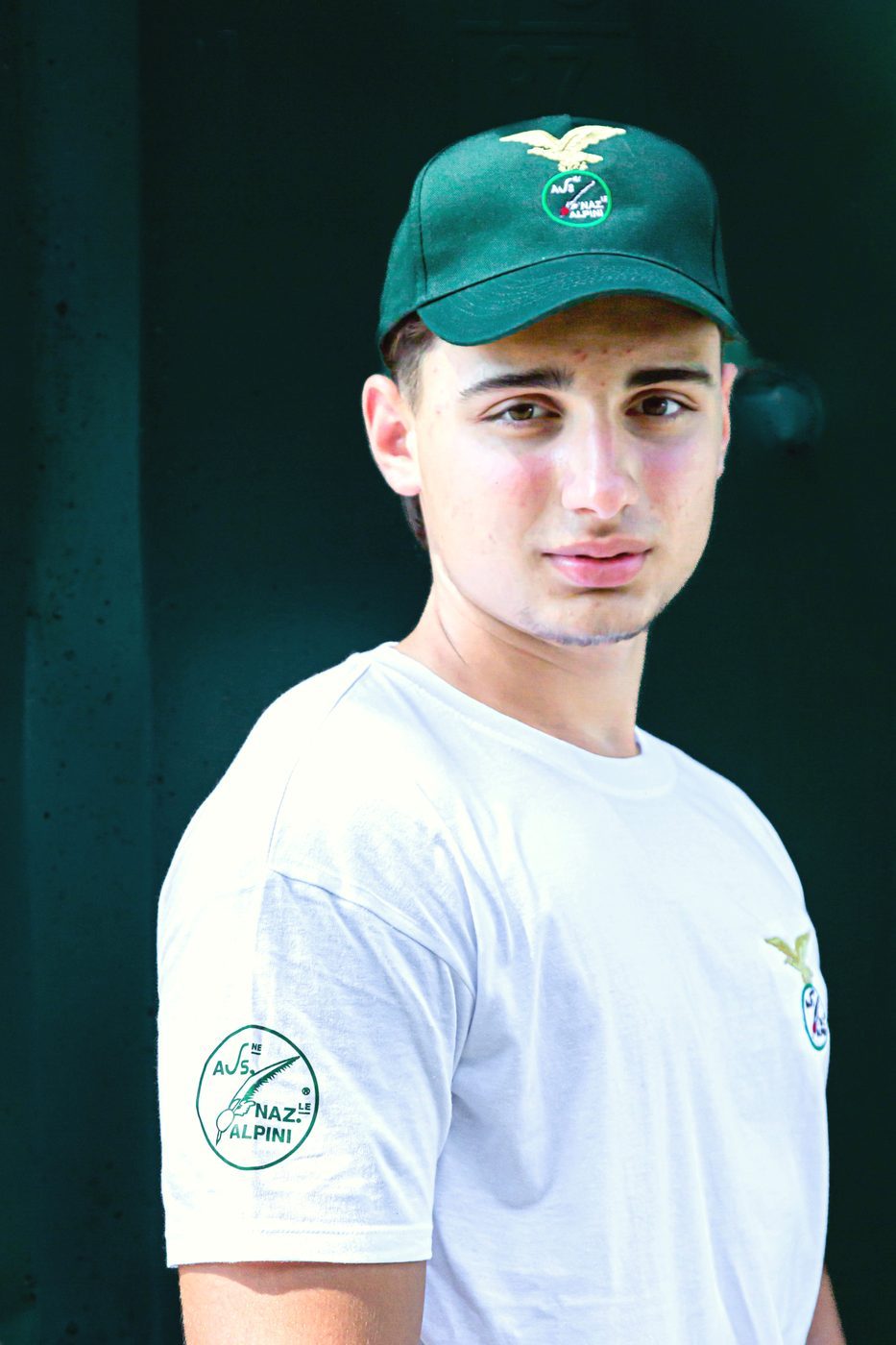 Cappellino verde e logo tondo Ass. Naz. Alpini sulla manica della maglietta